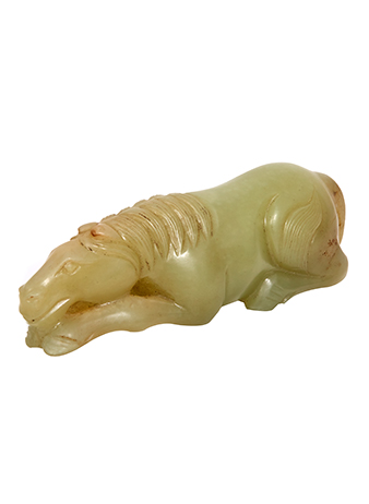 a small carved horse made from yellow jade 