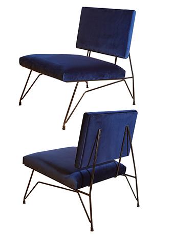 a pair of blue velvet chairs