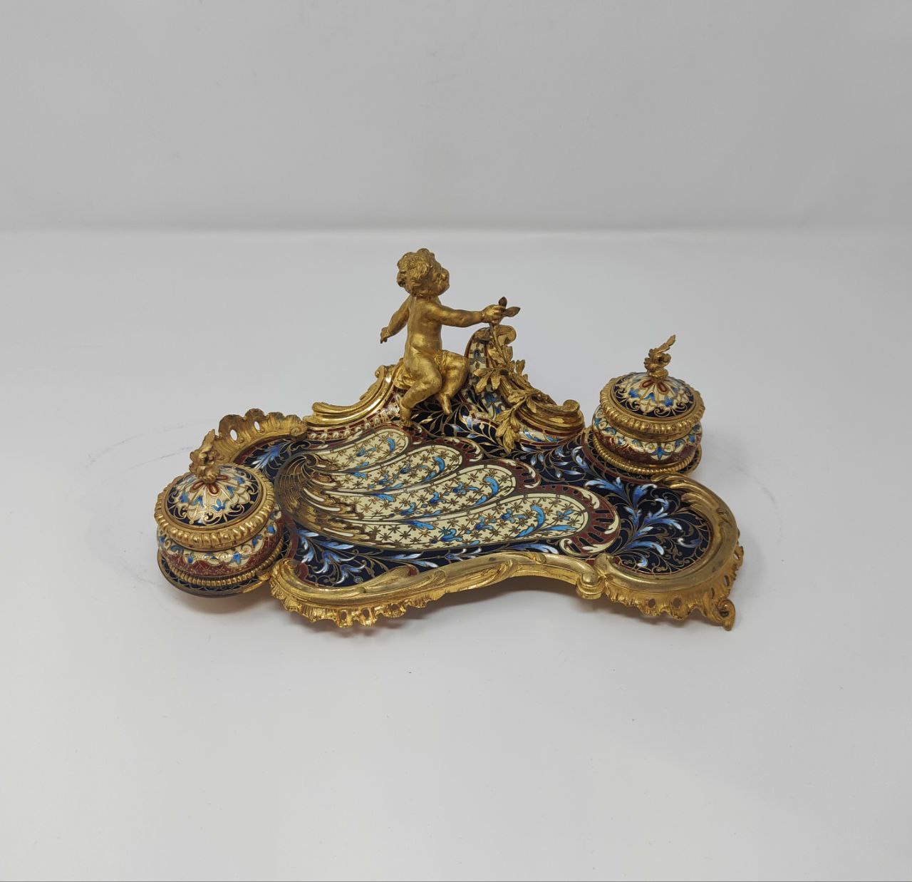 A bronze and champleve enamel inkwell